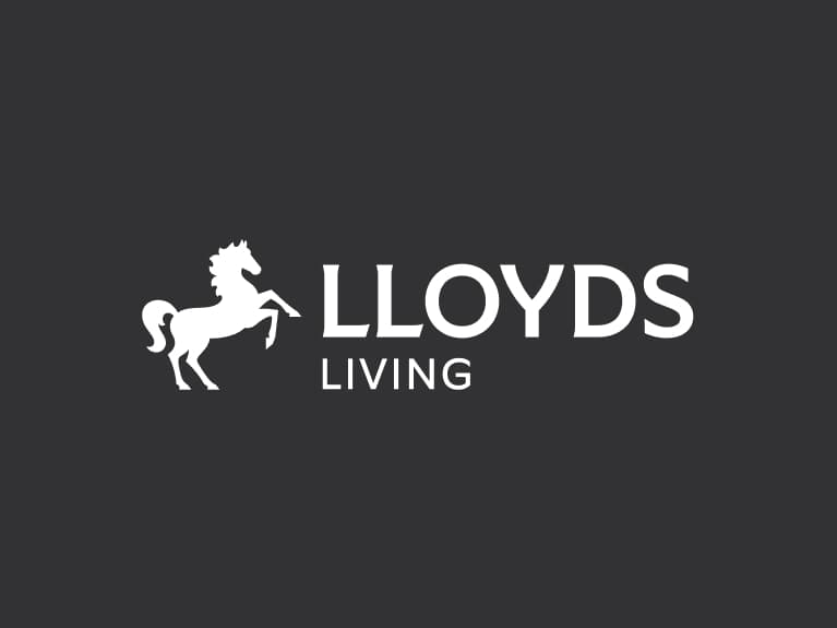 Lloyds Living secondary logo reversed has white horse positioned to the left of white 'Lloyds Living' wording.
